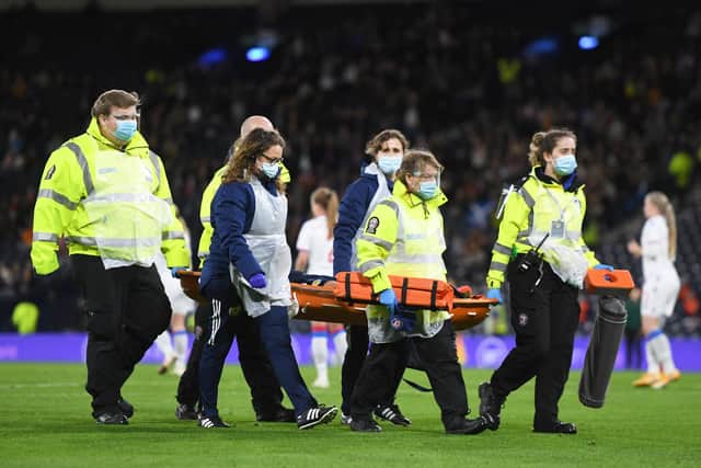 Scotland's Erin Cuthbert leaves the field on a stretcher.