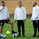 Hibs coaching team of Jamie McAllister (L). Adam Owens and David Gray (R) during a training session at East Mains.