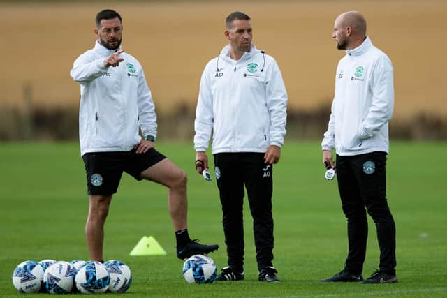 Hibs coaching team of Jamie McAllister (L). Adam Owens and David Gray (R) during a training session at East Mains.