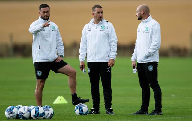 Hibs coaching team of Jamie McAllister (L). Adam Owens and David Gray (R) during a training session at East Mains.