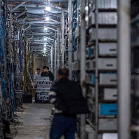 Workers transfer cryptocurrency mining rigs at a cryptocurrency farm which includes more than 3,000 mining rigs in Dujiangyan in China's southwestern Sichuan province. (Image credit: STR/AFP via Getty Images)
