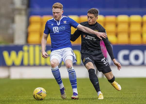 St Johnstone's James Brown and Livingston's Jaze Kabia in action.