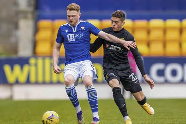 St Johnstone's James Brown and Livingston's Jaze Kabia in action.