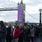 Members of the public in the queue at 06:19 on The Queen's Walk by Tower Bridge in London, as they wait to view Queen Elizabeth II lying in state ahead of her funeral on Monday. Picture date: Friday September 16, 2022.