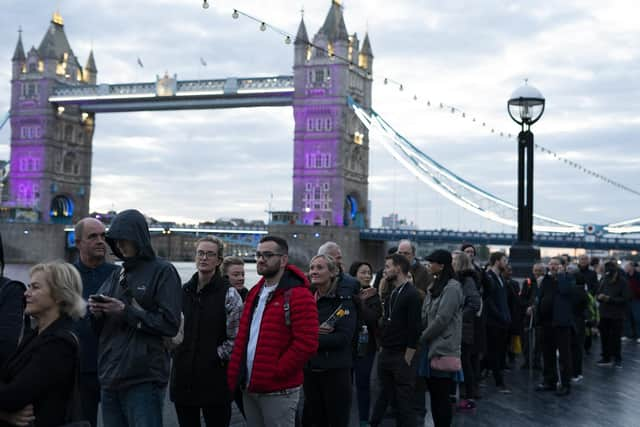 Members of the public in the queue at 06:19 on The Queen's Walk by Tower Bridge in London, as they wait to view Queen Elizabeth II lying in state ahead of her funeral on Monday. Picture date: Friday September 16, 2022.