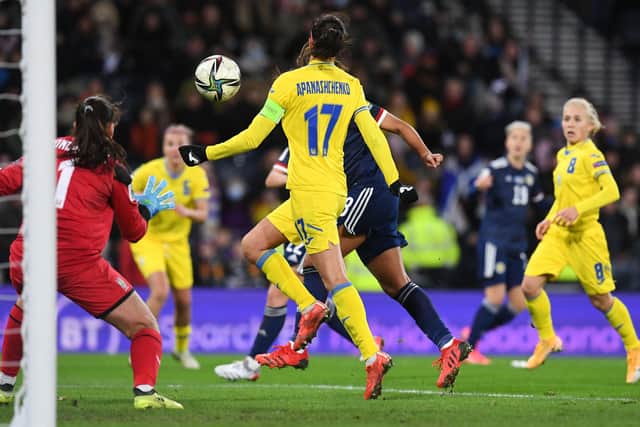 Abi Harrison heads home Scotland's equaliser against Ukraine.
