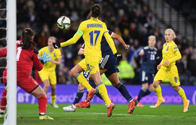 Abi Harrison heads home Scotland's equaliser against Ukraine.