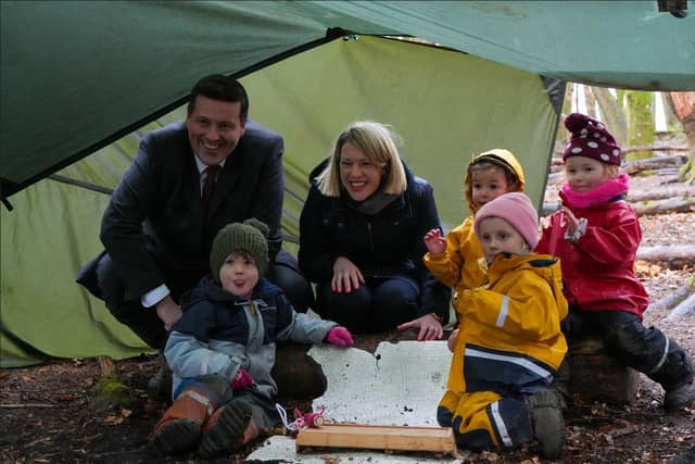 Independence Minister Jamie Hepburn and Education Secretary Jenny Gilruth with some of the children at the Secret Garden outdoor nursery, where they launched the Scottish Government's independence paper on education and lifelong learning. Image: Scottish Government.