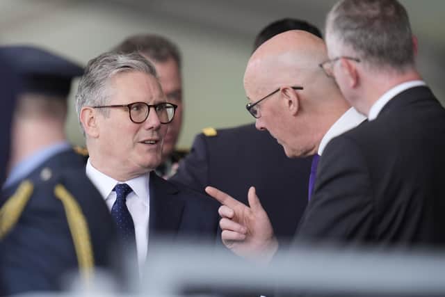 Labour leader Sir Keir Starmer (left) speaks to SNP First Minister John Swinney (Photo by Andrew Matthews/PA Wire)