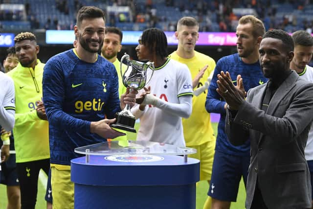 Tottenham's Hugo Lloris (L) is presented with the Walter Tull trophy by Jermain Defoe at full time. (Photo by Rob Casey / SNS Group)