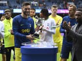 Tottenham's Hugo Lloris (L) is presented with the Walter Tull trophy by Jermain Defoe at full time. (Photo by Rob Casey / SNS Group)