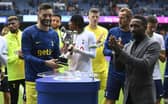 Tottenham's Hugo Lloris (L) is presented with the Walter Tull trophy by Jermain Defoe at full time. (Photo by Rob Casey / SNS Group)