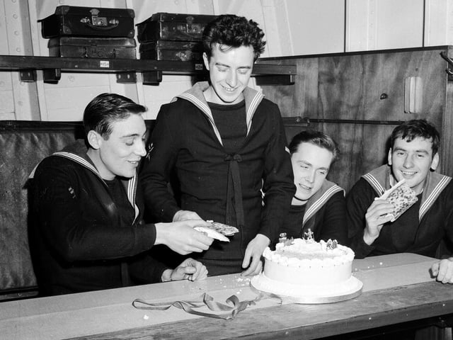 Sailors on the minesweeping ship HMS Wiston tuck into a Christmas cake that was a gift from people of Wiston, in Lanarkshire, in 1962.