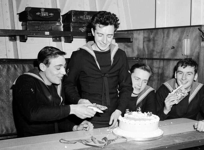 Sailors on the minesweeping ship HMS Wiston tuck into a Christmas cake that was a gift from people of Wiston, in Lanarkshire, in 1962.