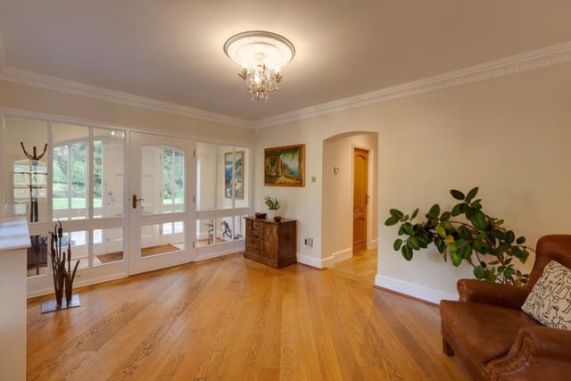 Natural light floods into the entrance hall where there are decorative ceiling roses and oak doors opening to the living kitchen, cloakroom/wc and inner hallway.