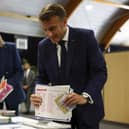French President Emmanuel Macron and his wife Brigitte Macron prepare to vote during the European election(Hannah McKay/Pool via AP)