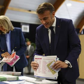 French President Emmanuel Macron and his wife Brigitte Macron prepare to vote during the European election(Hannah McKay/Pool via AP)