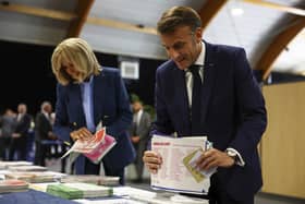 French President Emmanuel Macron and his wife Brigitte Macron prepare to vote during the European election(Hannah McKay/Pool via AP)