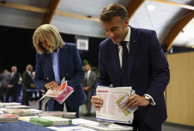 French President Emmanuel Macron and his wife Brigitte Macron prepare to vote during the European election(Hannah McKay/Pool via AP)