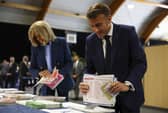 French President Emmanuel Macron and his wife Brigitte Macron prepare to vote during the European election(Hannah McKay/Pool via AP)