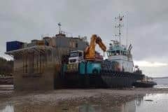 The damaged fish feed barge was beached in Reraig bay, on the edge of a marine protected area in Loch Carron, before Christmas to allow owner Bakkafrost to remove the hazardous cargo before towing it away
