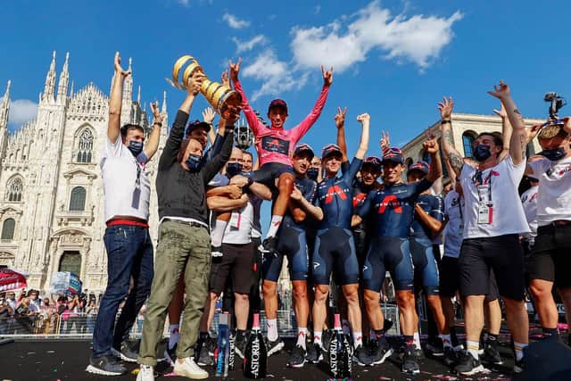 Team Ineos rider Colombia's Egan Bernal and his team celebrate with the race's Trofeo Senza Fine (Endless Trophy) on the podium after winning the Giro d'Italia 2021 cycling race following the 21st and last stage on May 30, 2021 in Milan.