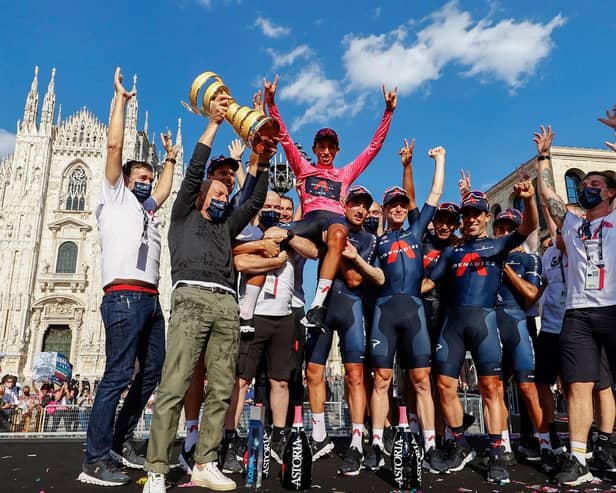 Team Ineos rider Colombia's Egan Bernal and his team celebrate with the race's Trofeo Senza Fine (Endless Trophy) on the podium after winning the Giro d'Italia 2021 cycling race following the 21st and last stage on May 30, 2021 in Milan.