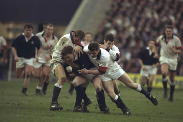 Michael Dods is stopped by Lawrence Dallaglio, Jon Sleightholme and Paul Grayson during the 1996 Five Nations Grand Slam decider against England at Murrayfield. England won 18-9.