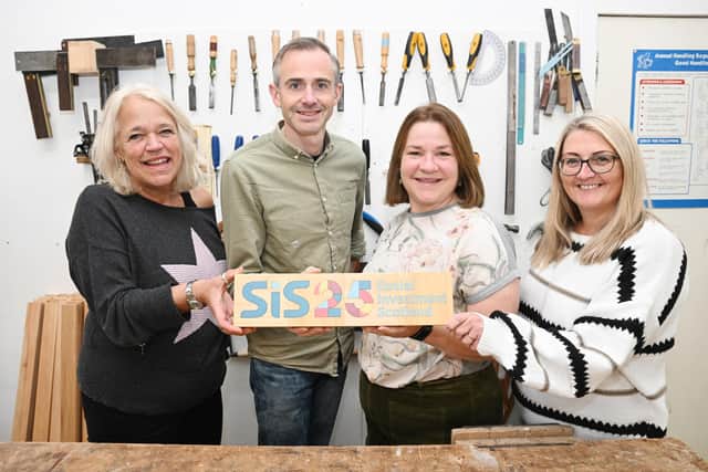 Lindsay Wake collects the Social Investment Scotland 25 plaque from Grassmarket Community Project where it was crafted (Picture: Greg Macvean)