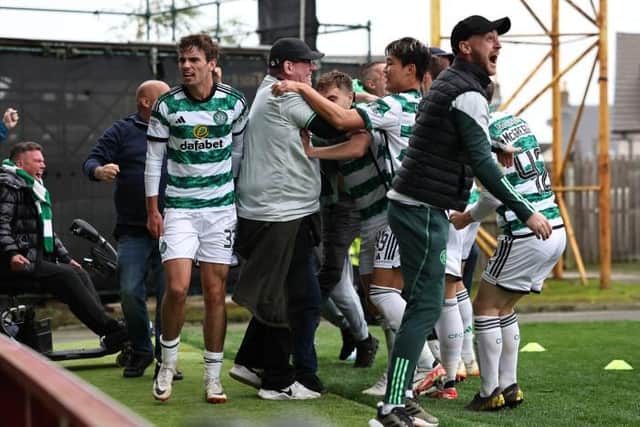 Matt O’Riley celebrates with fans after scoring to make it 2-1 to Celtic at Fir Park. (Photo by Ross MacDonald / SNS Group)