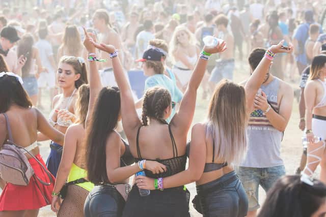 Festivalgoers enjoying a packed summer music event.