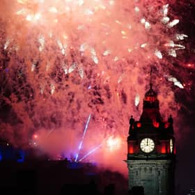 Fireworks explode over Edinburgh Castle and the Balmoral Hotel during Edinburgh's Hogmanay celebrations. Picture: Jane Barlow/PA Wire