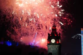 Fireworks explode over Edinburgh Castle and the Balmoral Hotel during Edinburgh's Hogmanay celebrations. Picture: Jane Barlow/PA Wire