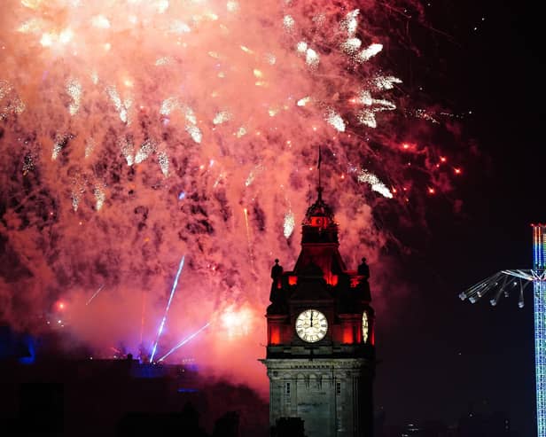 Fireworks explode over Edinburgh Castle and the Balmoral Hotel during Edinburgh's Hogmanay celebrations. Picture: Jane Barlow/PA Wire