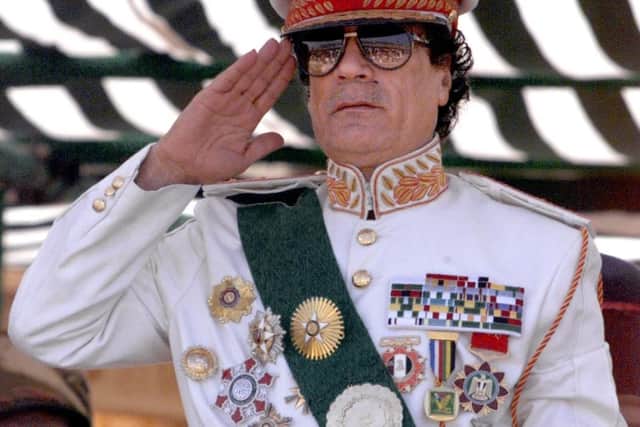 Former Libyan leader Muammar Gaddafi salutes during a five-hour military parade in Tripoli in 1999 to mark the 30th anniversary of the revolution that brought him to power (Picture: Marwan Naamani/AFP via Getty Images)