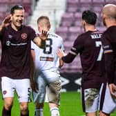 Hearts midfielder Peter Haring celebrates his goal with Jamie Walker and Steven Naismith.