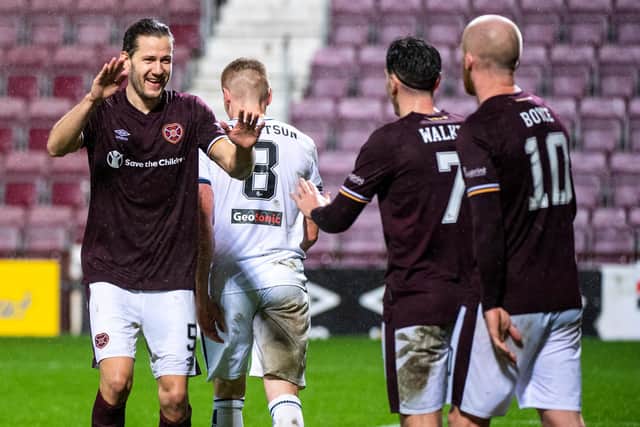 Hearts midfielder Peter Haring celebrates his goal with Jamie Walker and Steven Naismith.