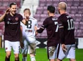 Hearts midfielder Peter Haring celebrates his goal with Jamie Walker and Steven Naismith.