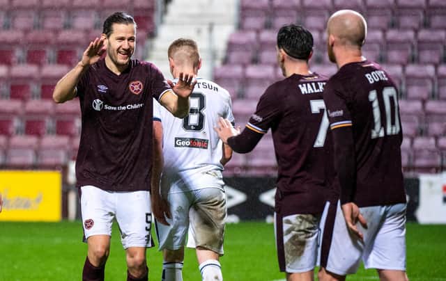 Hearts midfielder Peter Haring celebrates his goal with Jamie Walker and Steven Naismith.