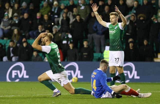 Hibs defender Ryan Porteous (left) reacts after a penalty was awarded to Rangers for his challenge on Ryan Kent at Easter Road on Wednesday night. (Photo by Craig Williamson / SNS Group)