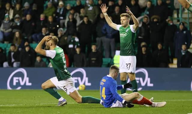 Hibs defender Ryan Porteous (left) reacts after a penalty was awarded to Rangers for his challenge on Ryan Kent at Easter Road on Wednesday night.  (Photo by Craig Williamson / SNS Group)