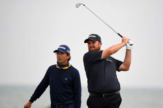 Defending champion Shane Lowry is watched by his coach, Edinburgh man Neil Manchip, during his first practice round for the 149th Open at Royal St George's. Picture: Andy Buchanan/AFP via Getty Images.