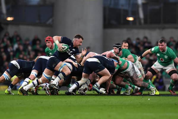 Jack Dempsey of Scotland runs with the ball clear of the scrum against Ireland.