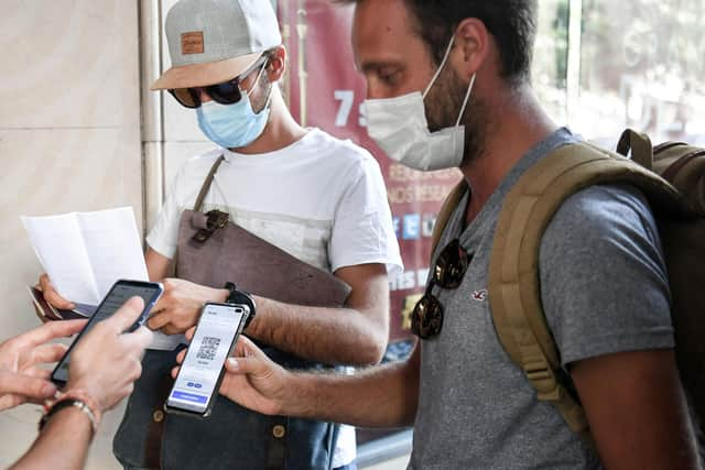 People have their Covid 'passport' checked before they enter a cinema in Paris (Picture: Alain Jocard/AFP via Getty Images)