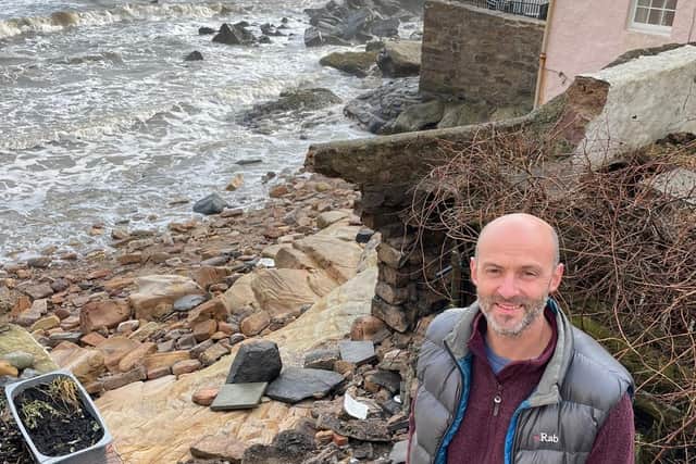 Rob Allen stands at the broken edge of his garden, which looks out over Pittenweem harbour