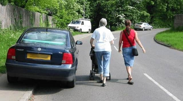 Vehicles blocking pavements put pedestrians at risk by forcing them onto roads