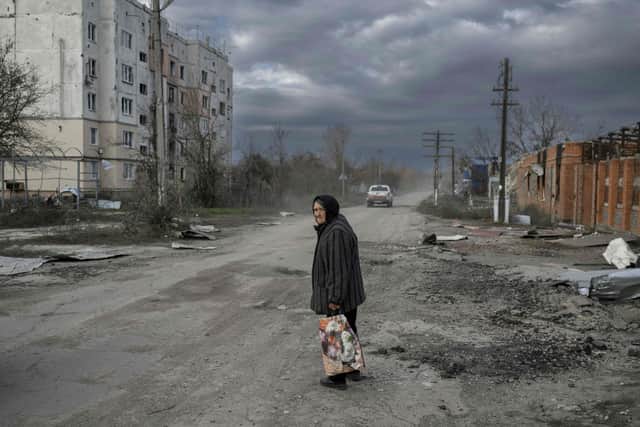 An old woman walks in the Kherson region village of Arkhanhelske, which was formerly occupied by Russian forces. Picture: Bulent Kilic/AFP via Getty Images