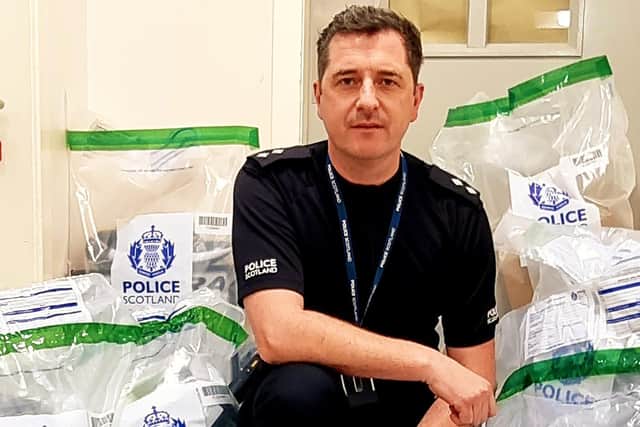Inspector Alan Mulholland with a haul of allegedly stolen parcels. Picture: Police Scotland