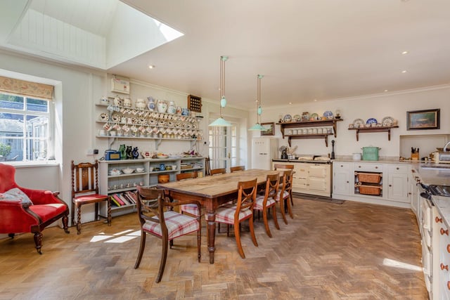 The east wing houses a very pretty traditional kitchen with wooden herringbone flooring and an AGA.