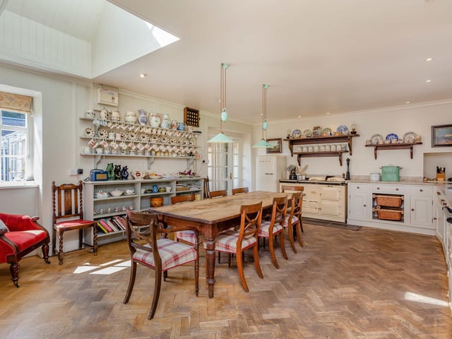 The east wing houses a very pretty traditional kitchen with wooden herringbone flooring and an AGA.
